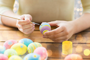 Image showing close up of woman hands coloring easter eggs