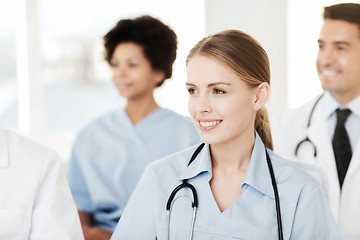 Image showing happy doctor over group of medics at hospital