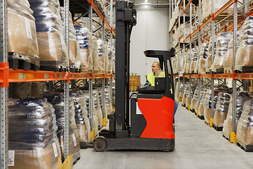 Image showing man on forklift loading cargo at warehouse