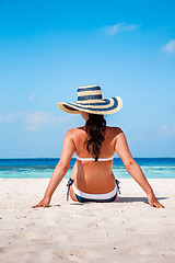 Image showing Girl walking along a tropical beach in the Maldives.