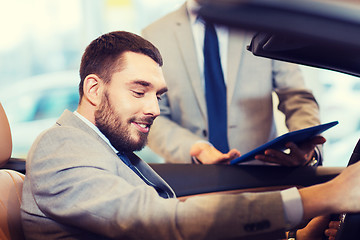 Image showing happy man with car dealer in auto show or salon