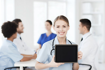 Image showing happy doctor over group of medics at hospital