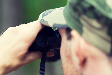 Image showing close up of soldier or hunter with binocular