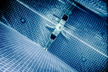 Image showing Persons standing under water in a swimming pool