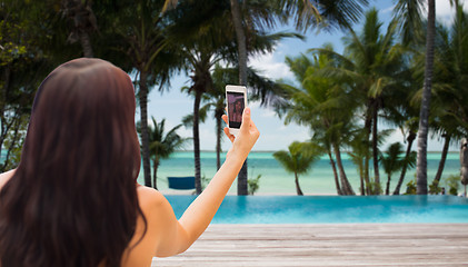 Image showing young woman taking selfie with smartphone