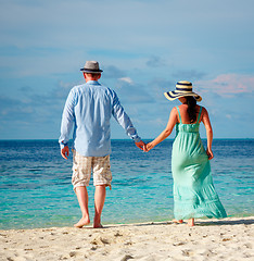 Image showing Vacation Couple walking on tropical beach Maldives.