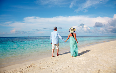 Image showing Vacation Couple walking on tropical beach Maldives.