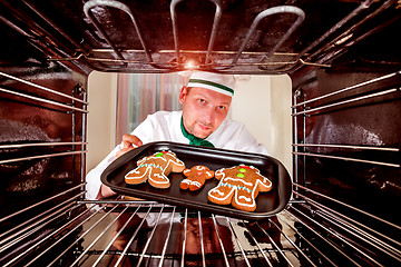 Image showing Baking Gingerbread man in the oven