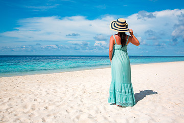 Image showing Girl walking along a tropical beach in the Maldives.