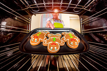 Image showing Baking Gingerbread man in the oven