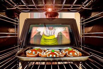 Image showing Baking Gingerbread man in the oven