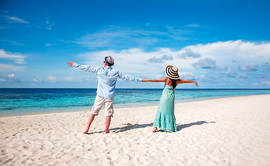 Image showing Vacation Couple walking on tropical beach Maldives.