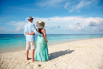 Image showing Vacation Couple walking on tropical beach Maldives.