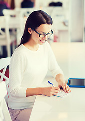 Image showing smiling woman with tablet pc at cafe