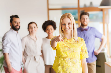 Image showing woman pointing to you over creative office team