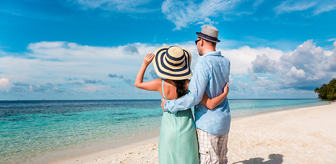 Image showing Vacation Couple walking on tropical beach Maldives.