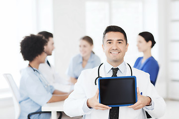 Image showing happy doctor with tablet pc over team at clinic