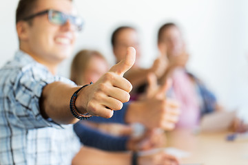 Image showing group of happy students showing thumbs up