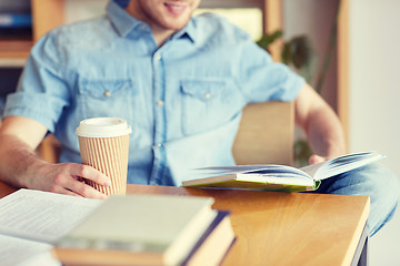 Image showing happy student reading book and drinking coffee