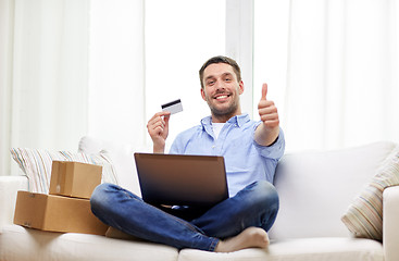 Image showing man with laptop and credit card showing thumbs up