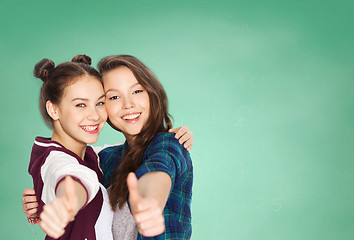 Image showing happy teenage student girls showing thumbs up