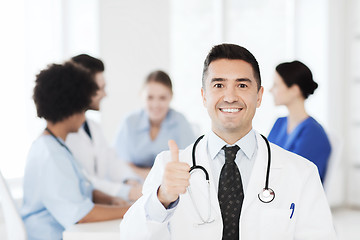 Image showing happy doctor over group of medics at hospital