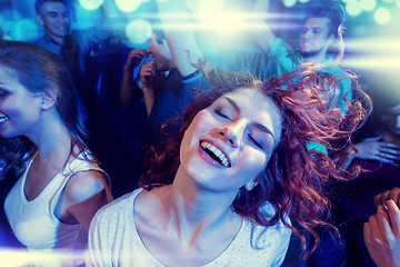 Image showing smiling friends dancing in club