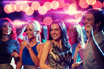 Image showing smiling friends dancing in club