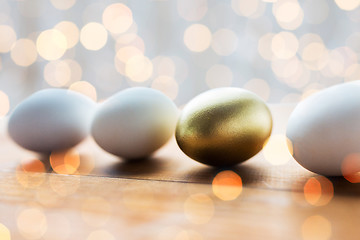 Image showing close up of golden and white easter eggs on wood