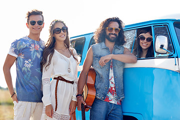 Image showing smiling young hippie friends over minivan car