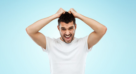 Image showing crazy shouting man in t-shirt over blue background