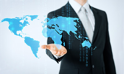 Image showing close up of man showing world map and binary code