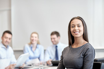 Image showing group of smiling businesspeople meeting in office