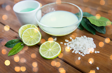 Image showing close up of body lotion, cream and salt on wood