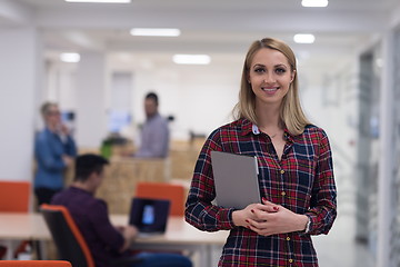 Image showing portrait of young business woman at office with team in backgrou