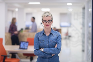 Image showing portrait of young business woman at office with team in backgrou