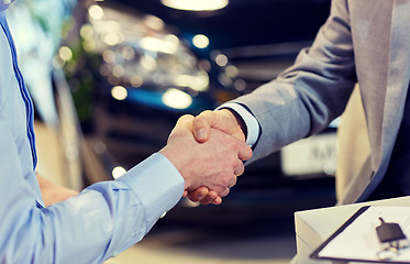 Image showing close up of male handshake in auto show or salon