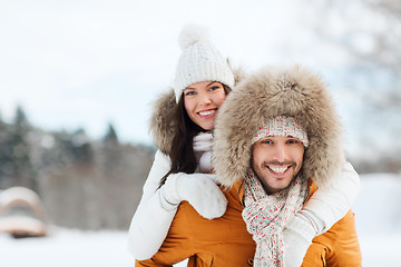 Image showing happy couple having fun over winter background