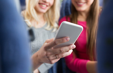 Image showing close up of women in travel bus with smartphone