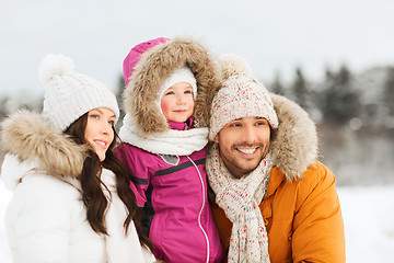 Image showing happy family with child in winter clothes outdoors