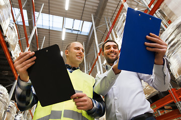 Image showing worker and businessmen with clipboard at warehouse