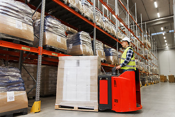 Image showing man on forklift loading cargo at warehouse