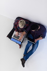 Image showing top view of  couple working on laptop computer at startup office