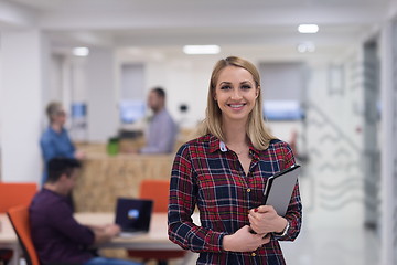 Image showing portrait of young business woman at office with team in backgrou