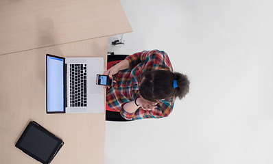 Image showing top view of young business woman working on laptop