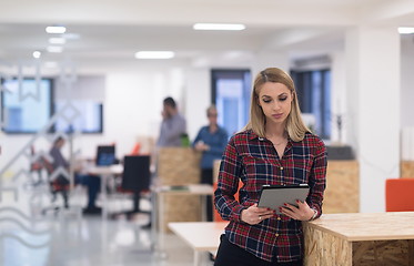 Image showing portrait of young business woman at office with team in backgrou