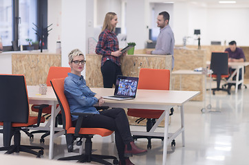 Image showing portrait of young business woman at office with team in backgrou
