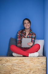 Image showing woman in crative box working on tablet