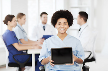 Image showing happy doctor over group of medics at hospital