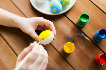 Image showing close up of woman hands coloring easter eggs